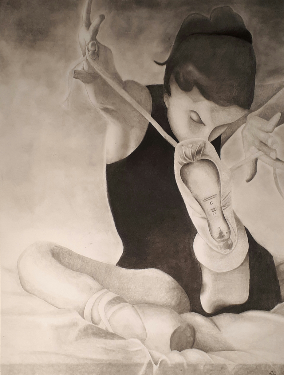 A framed monochrome charcoal artwork depicting a seated ballerina in a dark bodysuit holding a white object, shown against a smoky gray background with a black frame border.